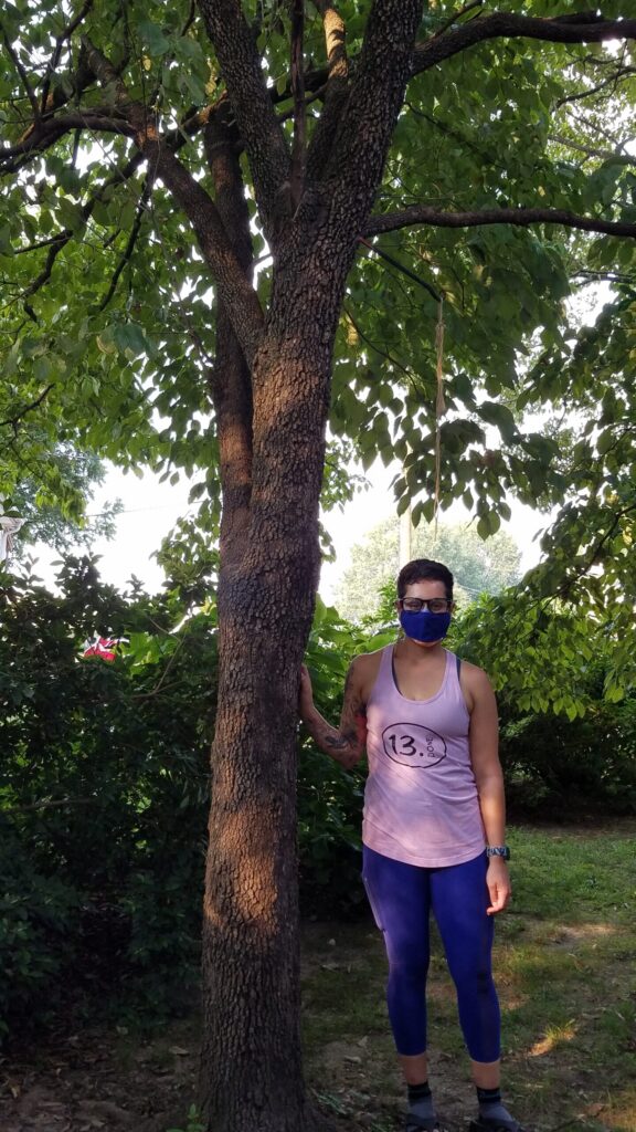 Deanna standing under het dogwood tree.