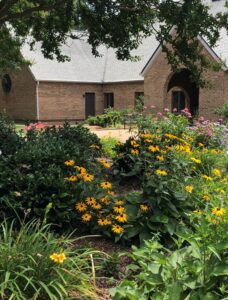 Photo of flowers in front of brick church